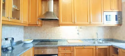 a kitchen with wooden cabinets and a sink at Sagres Mar in Sagres