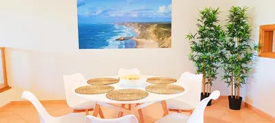 a white dining room with a white table and chairs at Sagres Mar in Sagres
