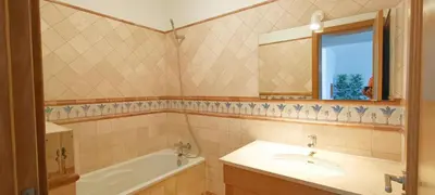 a bathroom with a sink and a tub and a mirror at Sagres Mar in Sagres
