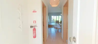 a hallway with a red scooter hanging on the wall at Sagres Mar in Sagres