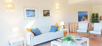 a living room with a white couch and two chairs at Sagres Mar in Sagres