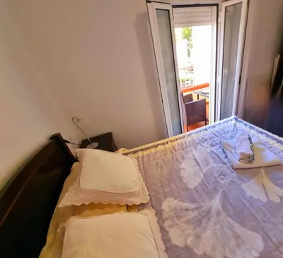 a bed with two pillows on it in a room at Ribeirinho Apartment - Machico Beach in Machico