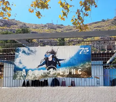 a banner on a fence with a woman on it at Ribeirinho Apartment - Machico Beach in Machico