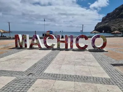 a large sign that says marinho on a beach at Ribeirinho Apartment - Machico Beach in Machico