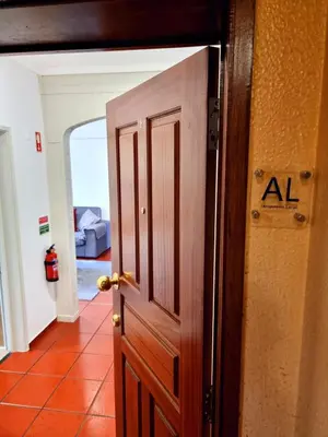 an open door with an al sign on it at Ribeirinho Apartment - Machico Beach in Machico