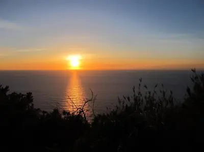 a sunset over the ocean with the sun in the sky at Casa do Bisbis in Lanceiros