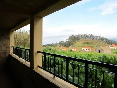 a balcony with a view of a field of crops at Casa do Bisbis in Lanceiros