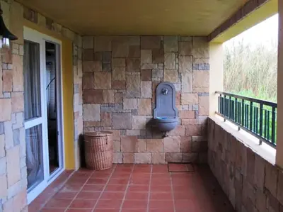 a stone wall on a porch with a trash can at Casa do Bisbis in Lanceiros