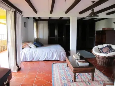 a bedroom with a bed and a table and a chair at Casa do Bisbis in Lanceiros
