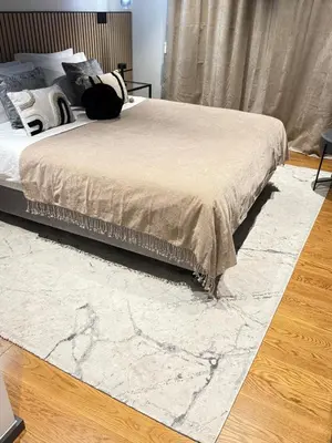 a bedroom with a bed with a marble rug at Zukiryo Seaside by Rentallido in Funchal