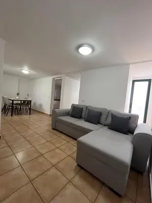 a living room with a couch and a table at Casa Pão - 5 mins from Machico centre with private parking in Machico