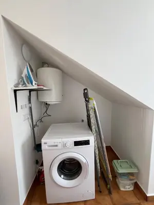 a washer and dryer in a small room at Casa Pão - 5 mins from Machico centre with private parking in Machico