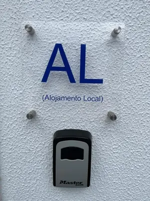 aaa sign on the side of a wall with a toaster at Casa Pão - 5 mins from Machico centre with private parking in Machico