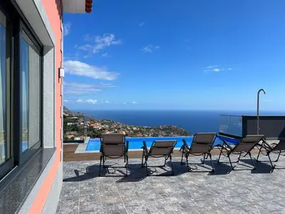 a group of chairs sitting on top of a building at Villa Diogo in Ponta do Sol