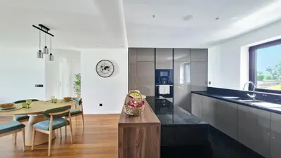 a kitchen with a table and a dining room at Blissful Suite by LovelyStay in Funchal