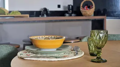 a bowl and a glass sitting on a table at Blissful Suite by LovelyStay in Funchal