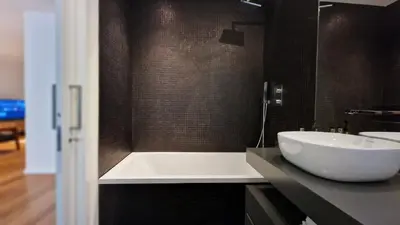 a bathroom with a white tub and a sink at Blissful Suite by LovelyStay in Funchal