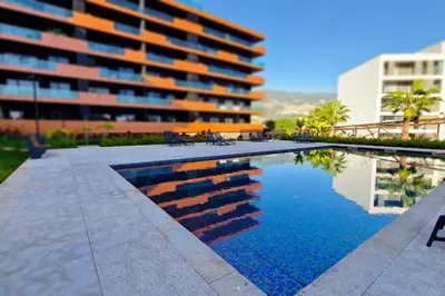 a swimming pool in front of a building at Blissful Suite by LovelyStay in Funchal
