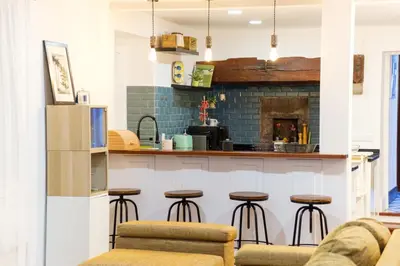 a kitchen with bar stools and a fireplace at GuestReady - Peaceful haven in Funchal in Funchal