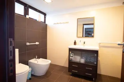 a bathroom with a sink and a toilet and a mirror at GuestReady - Peaceful haven in Funchal in Funchal