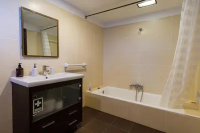 a bathroom with a sink and a tub and a mirror at GuestReady - Peaceful haven in Funchal in Funchal