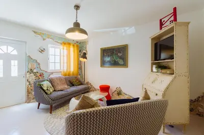 a living room with a couch and chairs at Casa Colorida in Vila do Bispo