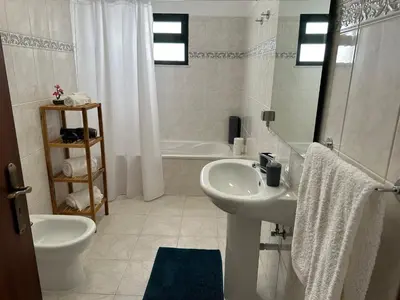 a bathroom with a sink and a toilet and a shower at Refúgio dos Prazeres - Madeira Inn Group in Prazeres