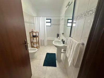 a bathroom with a sink and a toilet at Refúgio dos Prazeres - Madeira Inn Group in Prazeres