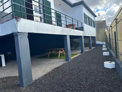 a building with a picnic table on the side of it at Refúgio dos Prazeres - Madeira Inn Group in Prazeres
