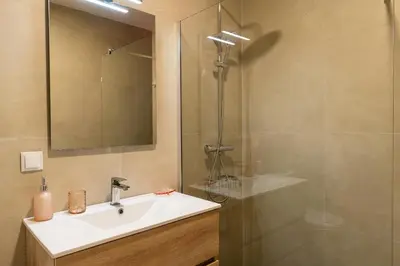 a bathroom with a sink and a shower at Mouras House, Arco da Calheta in Arco da Calheta