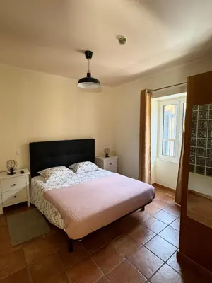 a bedroom with a large bed and a window at Old Zone Apartment - 1º C in Funchal
