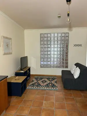 a living room with a bed and a tv at Old Zone Apartment - 1º C in Funchal