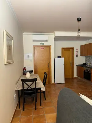 a kitchen and dining room with a table and a refrigerator at Old Zone Apartment - 1º C in Funchal