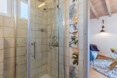 a shower with a glass door in a bathroom at Casa tempo e amor in Vila do Bispo