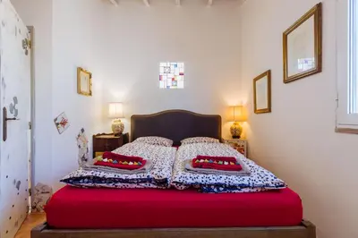 a bedroom with a bed with two pillows on it at Casa tempo e amor in Vila do Bispo
