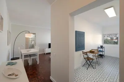 a room with white walls and a table and chairs at Apartamento Jaime Moniz by An Island Apart in Funchal