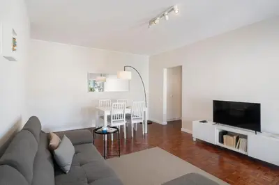 a living room with a couch and a tv and a table at Apartamento Jaime Moniz by An Island Apart in Funchal