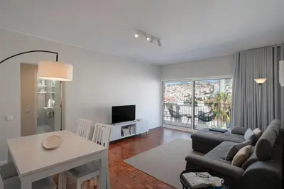 a living room with a couch and a table at Apartamento Jaime Moniz by An Island Apart in Funchal