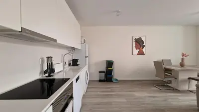 a kitchen with white counters and a table and a table at Carmo City Palace by LovelyStay in Funchal