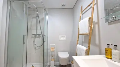 a bathroom with a shower and a toilet and a sink at Carmo City Palace by LovelyStay in Funchal