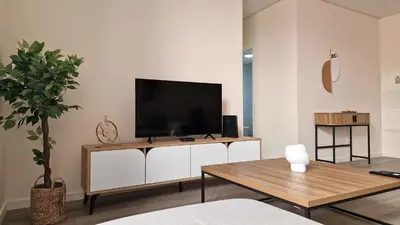 a living room with a flat screen tv on a white cabinet at Carmo City Palace by LovelyStay in Funchal