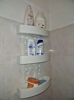 a shelf in a bathroom with some shampoo and conditioners at House in Camara de Lobos in Estreito de Câmara de Lobos