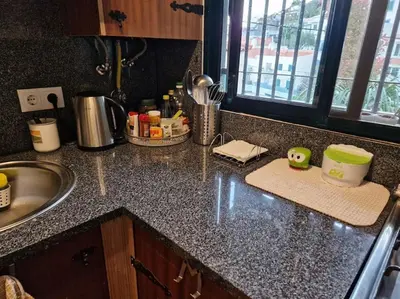 a kitchen counter top with a sink and a counter top at House in Camara de Lobos in Estreito de Câmara de Lobos