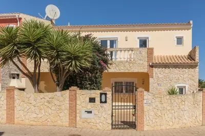a stone fence in front of a house at Villa Arpeggio - Cozy 3-Bedroom Villa with Private Pool in Montinhos da Luz, Lagos in Mato Porcas