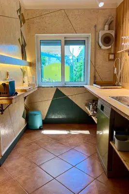 a kitchen with a window and a tiled floor at Private renovated APT w pool, 3m to praia da Luz in Valverde