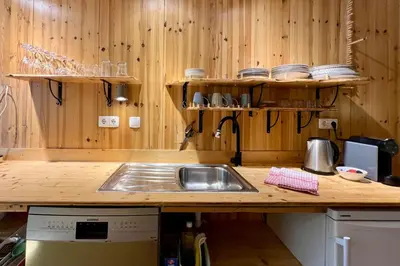 a kitchen with a sink and a counter with wooden walls at Private renovated APT w pool, 3m to praia da Luz in Valverde