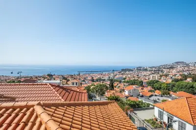 an aerial view of a city with orange roofs at Diogo House - view Funchal in Funchal