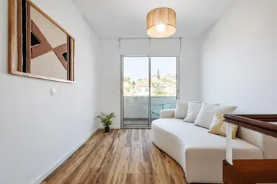 a white living room with a couch and a window at Diogo House - view Funchal in Funchal