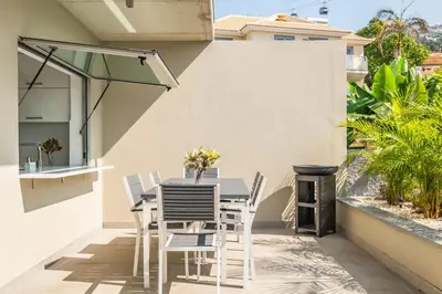 a patio with a table and chairs and a grill at Diogo House - view Funchal in Funchal