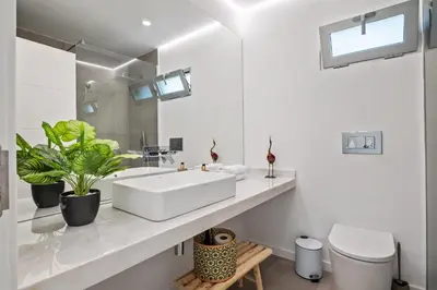 a white bathroom with a sink and a toilet at Diogo House - view Funchal in Funchal